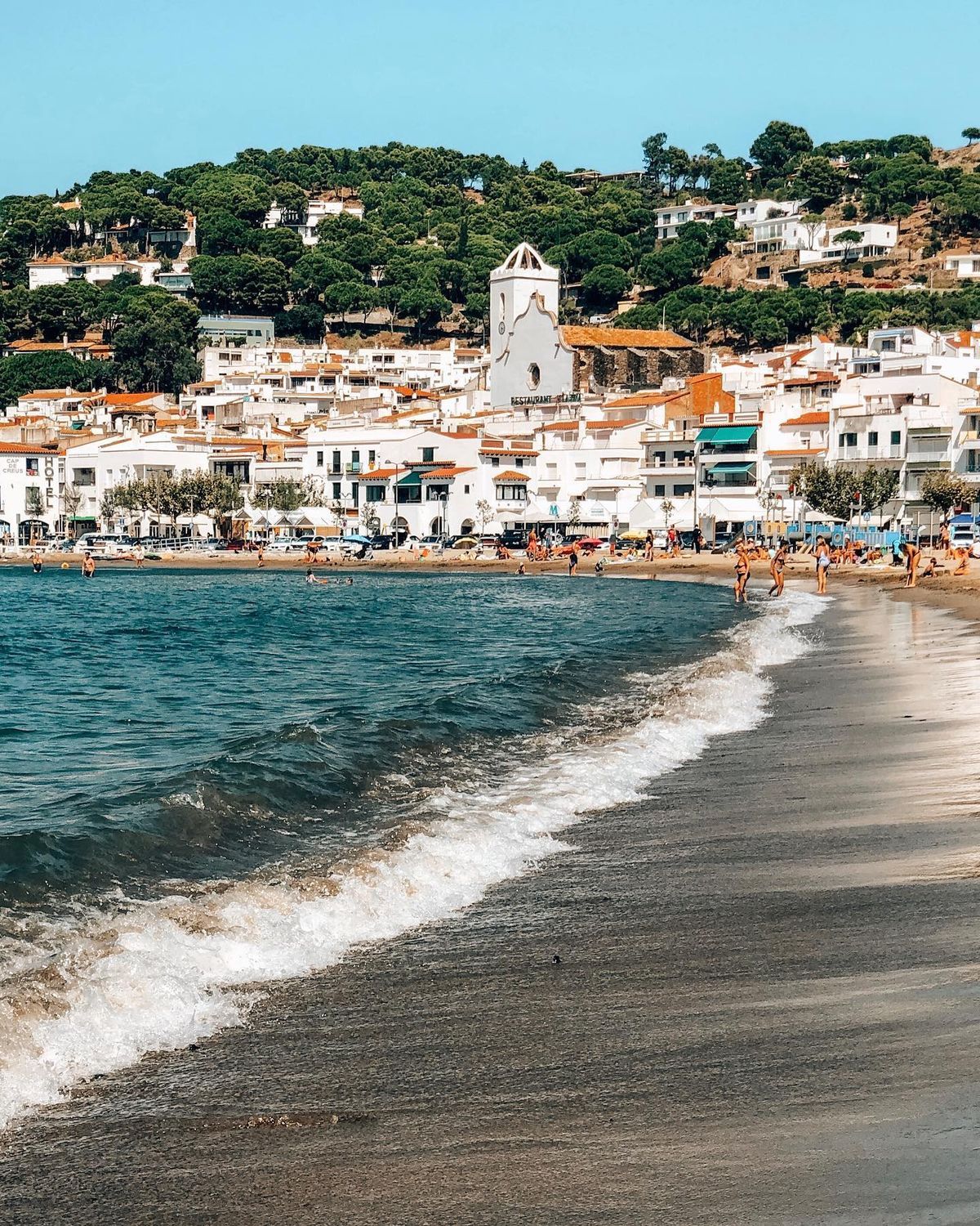 A whitewashed village above a small beach on the Catalan coast